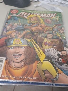 DC Aquaman Comic Cover – Green, Yellow, Blue Accents In A Sleeve
